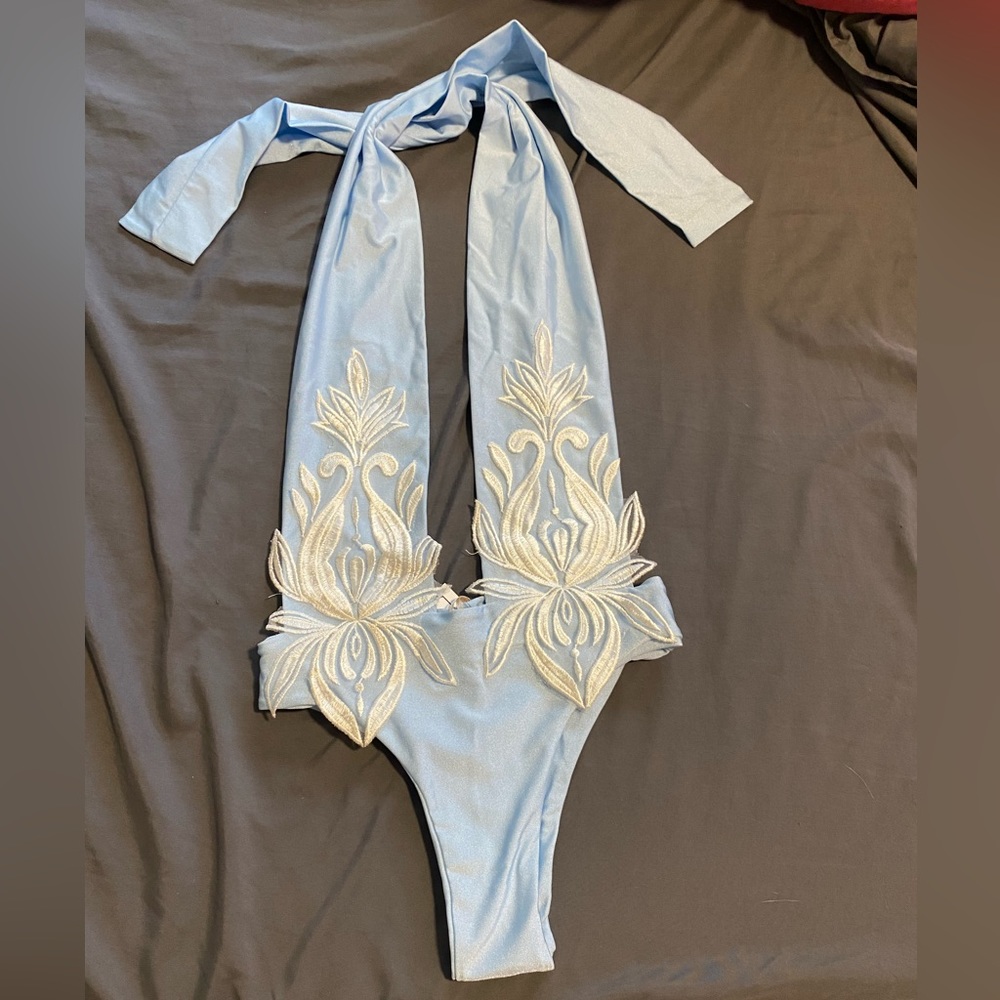 Elegant Italian swimsuit with plunging neckline. Sky blue with white appliqué.
